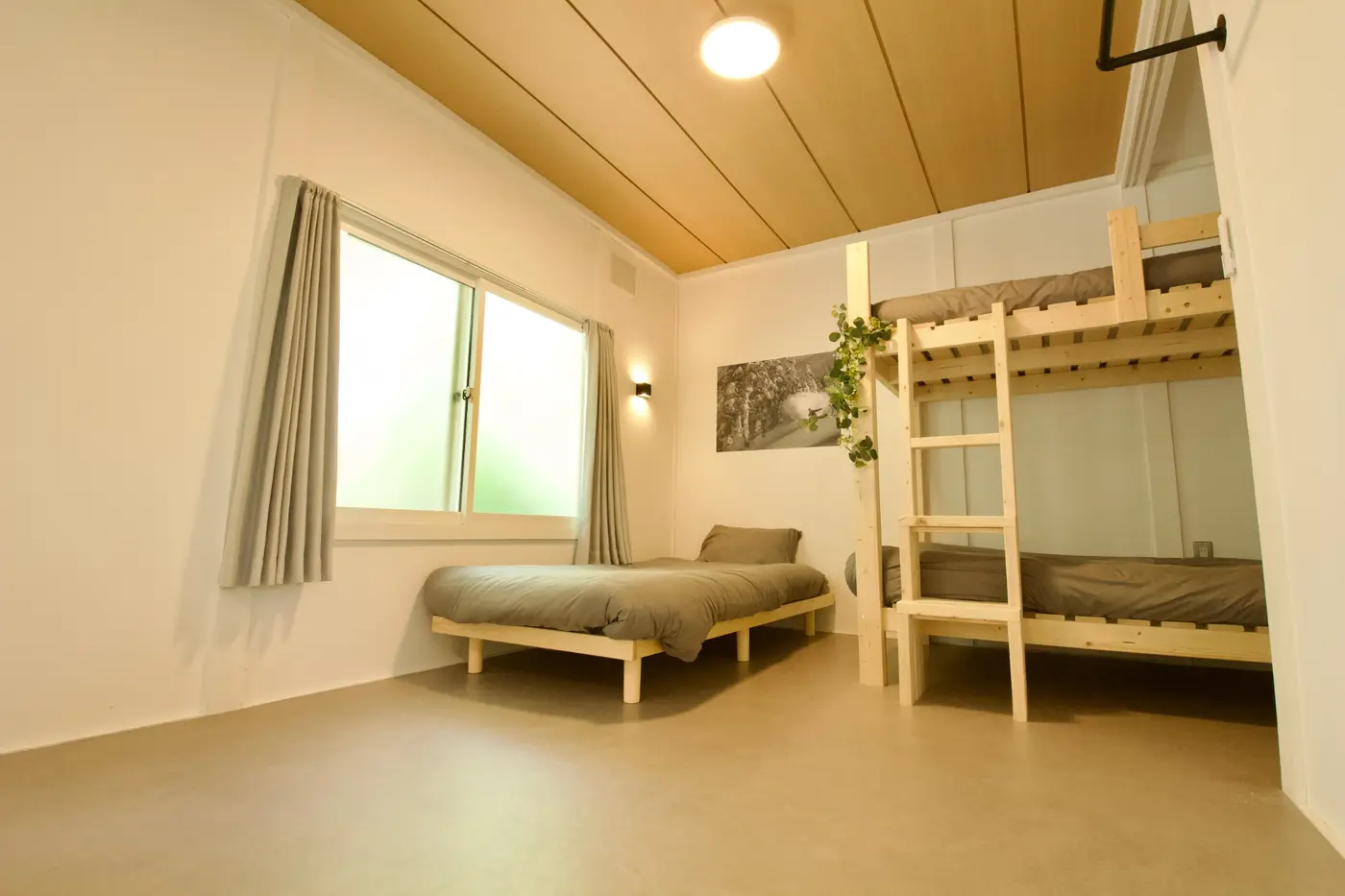 Bedroom with a wooden bunk bed and a single bed